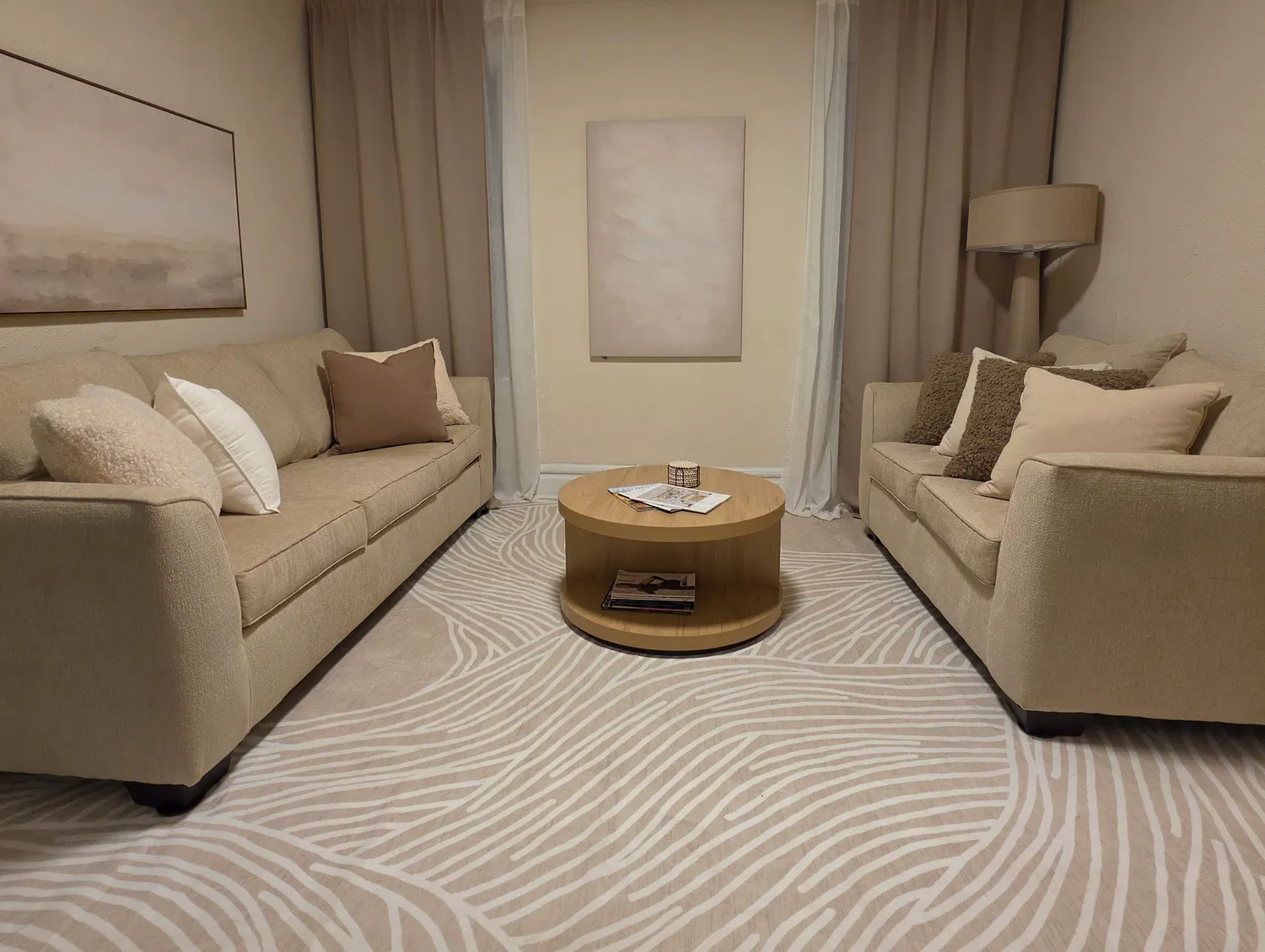 LaSerene at Newark — living room with beige sofas and patterned rug