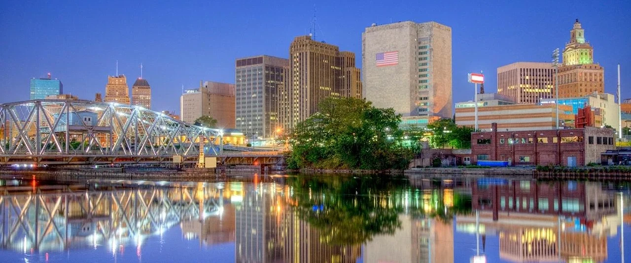 Newark skyline, illuminated bridge and reflections on the Passaic River at dusk