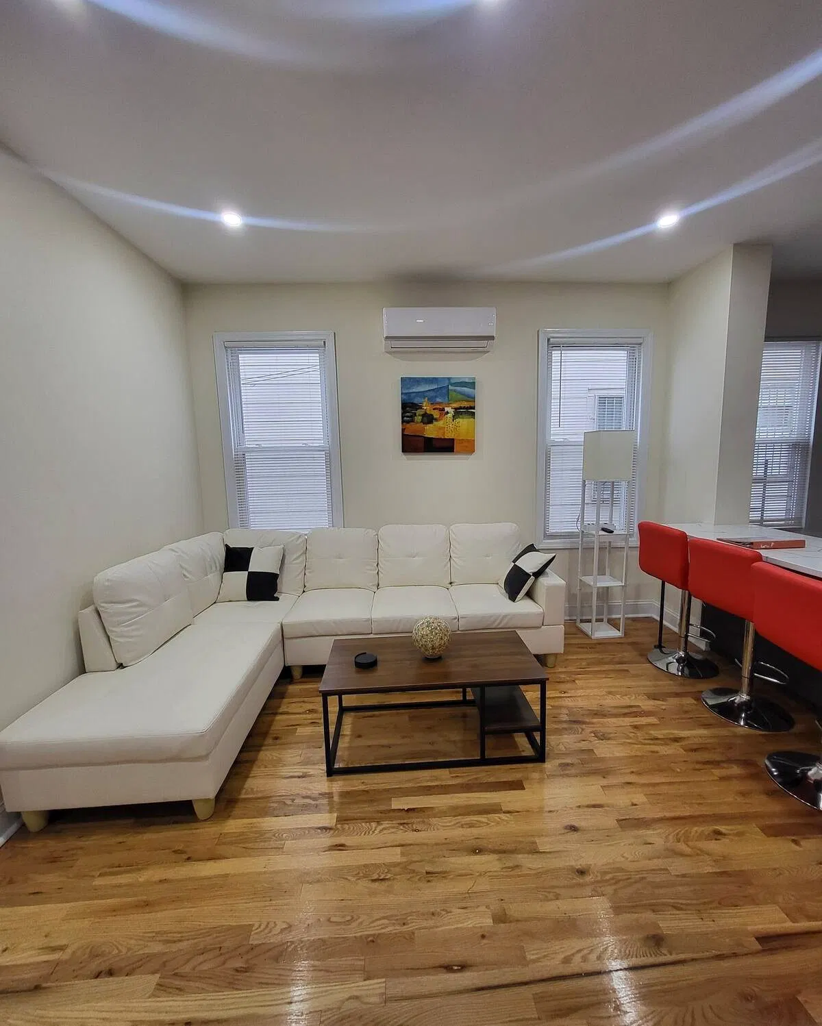 OoohLaLa@Newark — A bright and versatile gathering space with wall-mounted television and hardwood floors.
